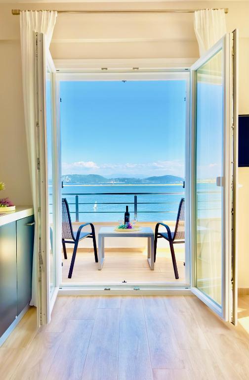 a dining room with a view of the ocean at Sea Sparkle 1a in Preveza