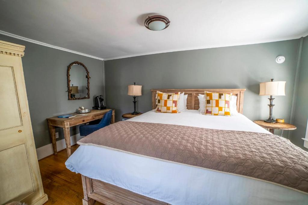 a bedroom with a large bed and a mirror at Hellbender Bed & Beverage in Blowing Rock