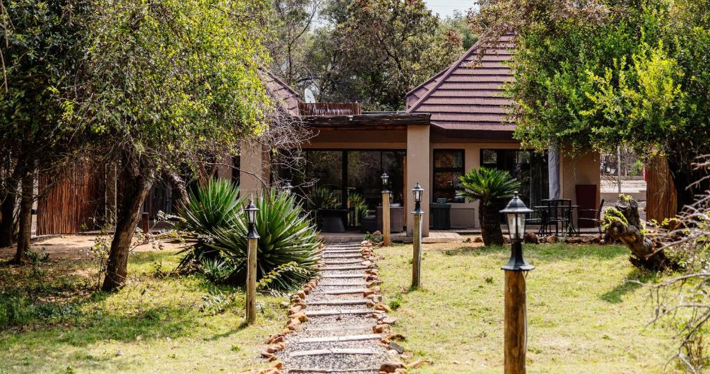 a house with a stone path in front of it at Mabalingwe Nature Reserve - Elephant Lodge - Tjaila in Warmbaths