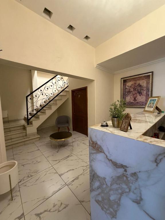 a lobby with a marble floor and a staircase at Hotel Casa Victoria in Tequila