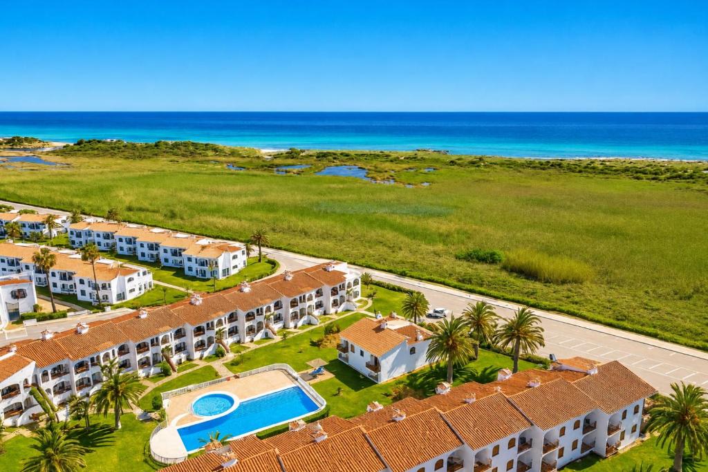 an aerial view of a resort with a swimming pool at Turquoise Menorca By the Sea in Son Bou