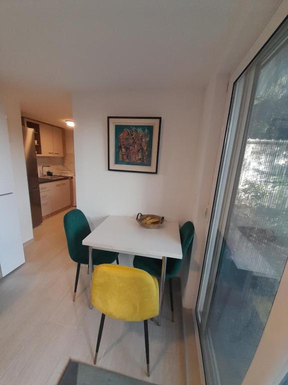 a table and chairs in a room with a window at Apart SRDJ&MAR in Dobra Voda