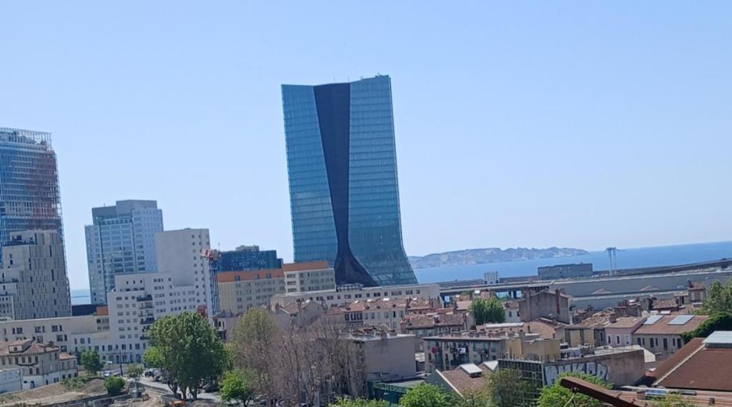 a view of a city with a tall skyscraper at lits superposé in Marseille