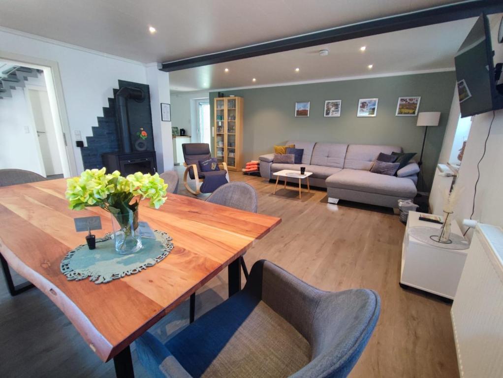 a living room with a wooden table and a couch at Ferienhaus Quell in Sankt Martin