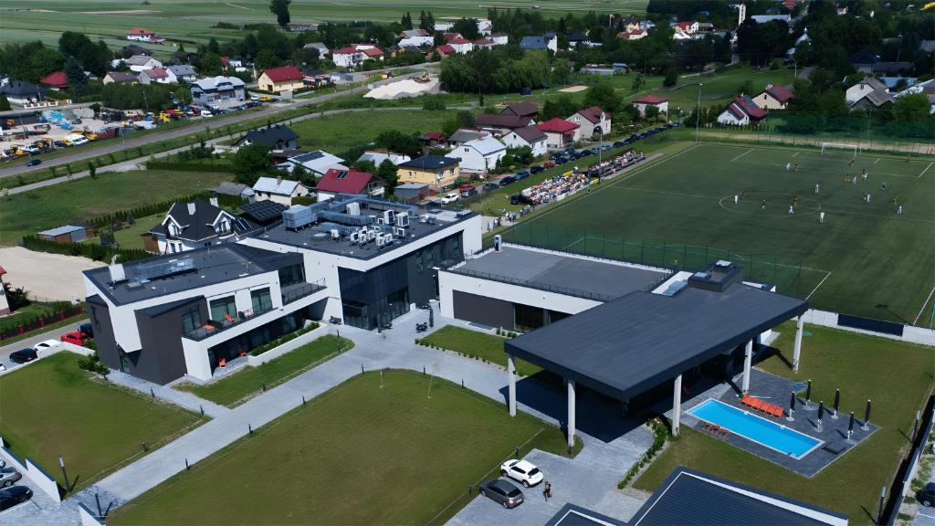 an aerial view of a house with a tennis court at Soccer Box Pro in Dachnów
