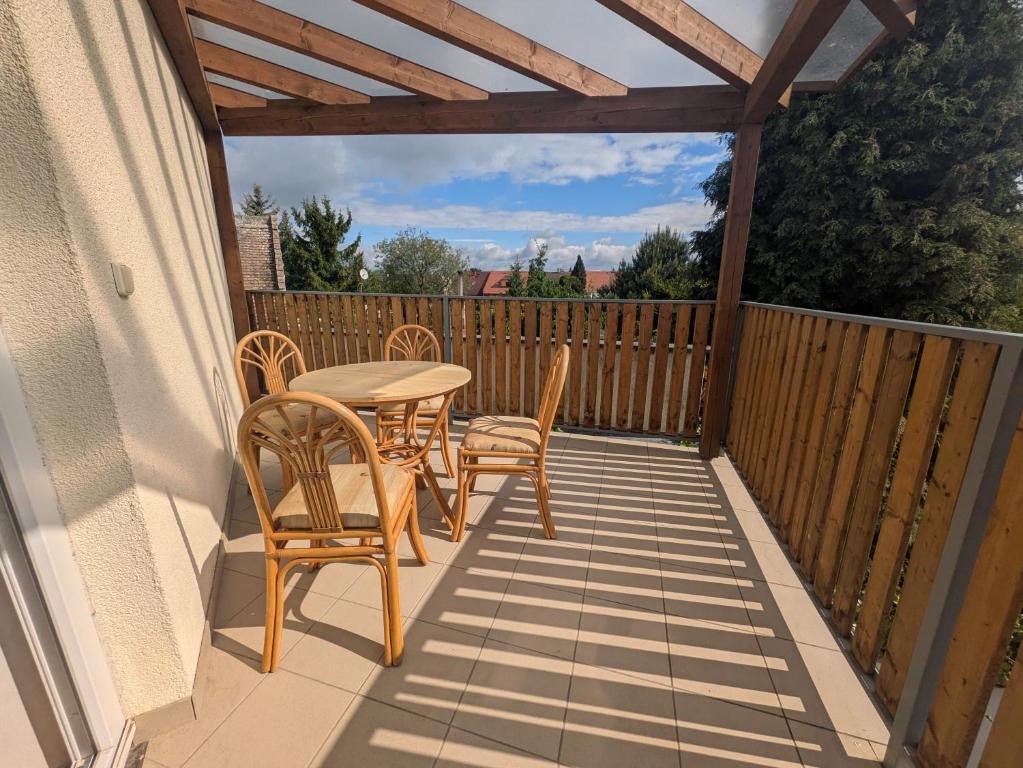 a patio with a table and chairs on a deck at Apartman Amanda in Poděbrady
