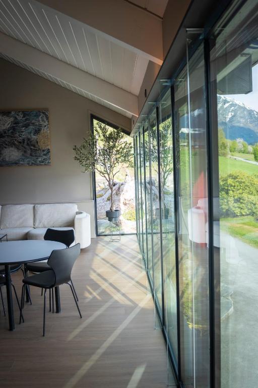 a living room with a table and chairs and glass walls at Reed Panorama in Reed