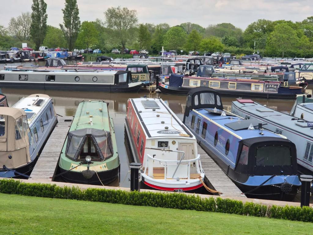 a bunch of boats are parked in a marina at Komet Canal Boats in Nantwich