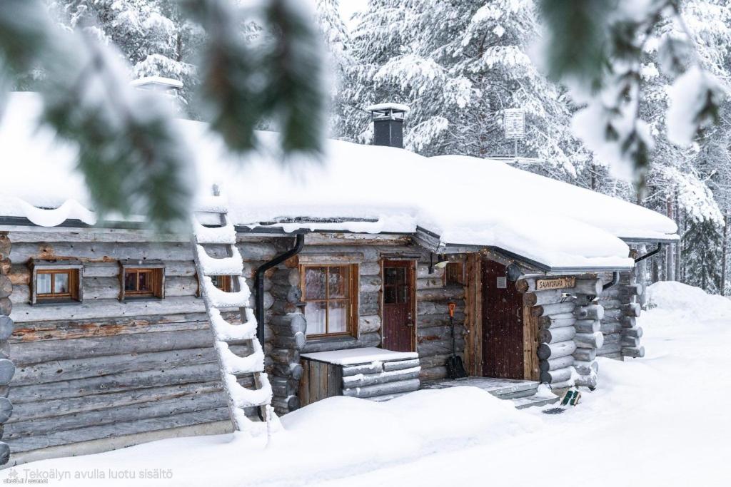 a log cabin with snow on the roof at Kelo Haven, 2 x skipasses Ruka-Pyhä included, skibus nearby in Ruka