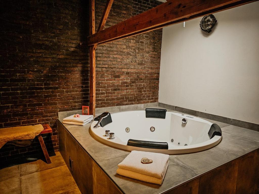 a bath tub sitting on a counter in a bathroom at Hut 16 Bed, stad & privé wellness in Zutphen