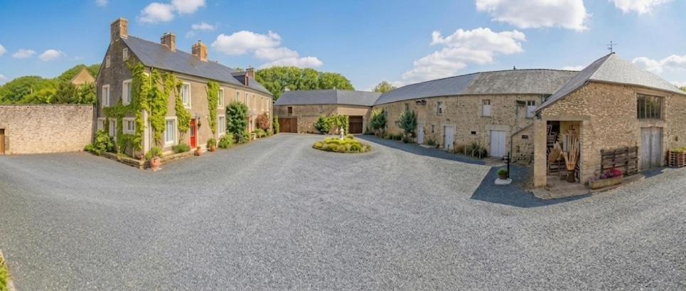 a large driveway in front of a building at Domaine Aux Léopards Normands in Mandeville-en-Bessin