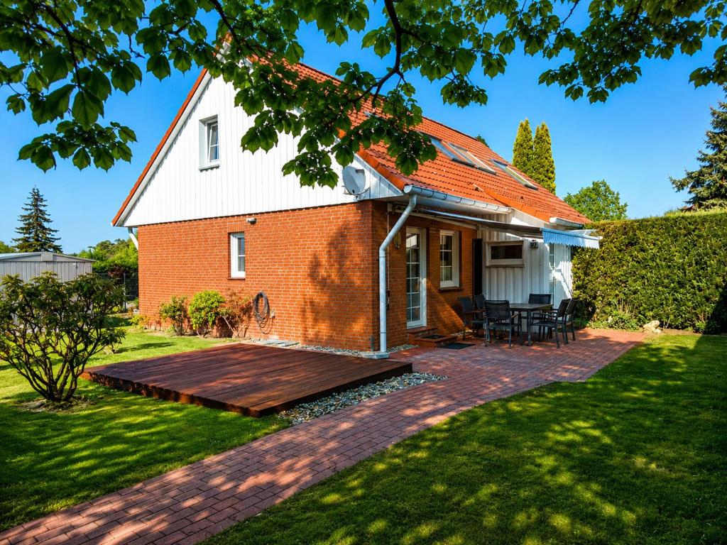 a red brick house with an orange roof at Ostseeferienhaus Usedom Lütow am Achterwasser Hundefreundlich Naturlage Familie Christian Ziethen in Lütow