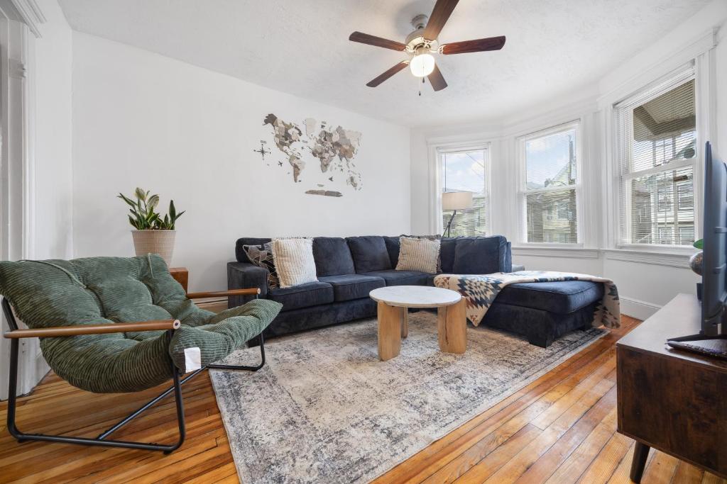 a living room with a couch and a ceiling fan at Spacious & Stylish 2BR Apartment Near Manhattan in Jersey City