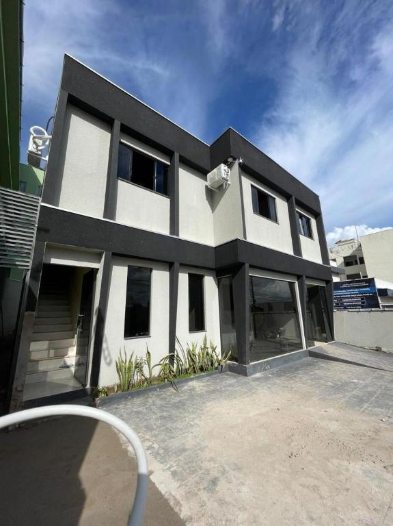 a white and black house with a lot of windows at Maresia in Cacoal