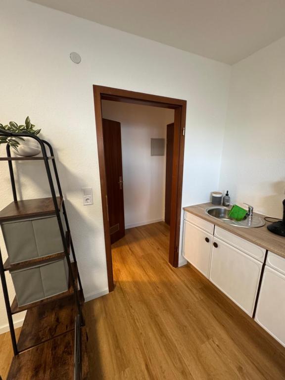 a kitchen with a ladder next to a sink at Münchberg Ferienwohnung, Monteurszimmer in Münchberg