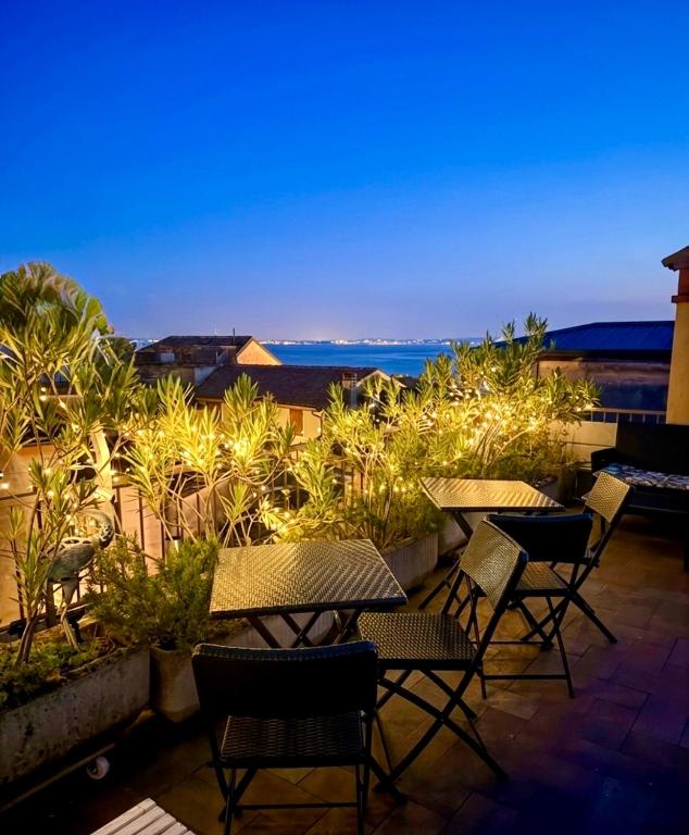 a group of tables and chairs on a patio at Casa Cavour Garda in Garda