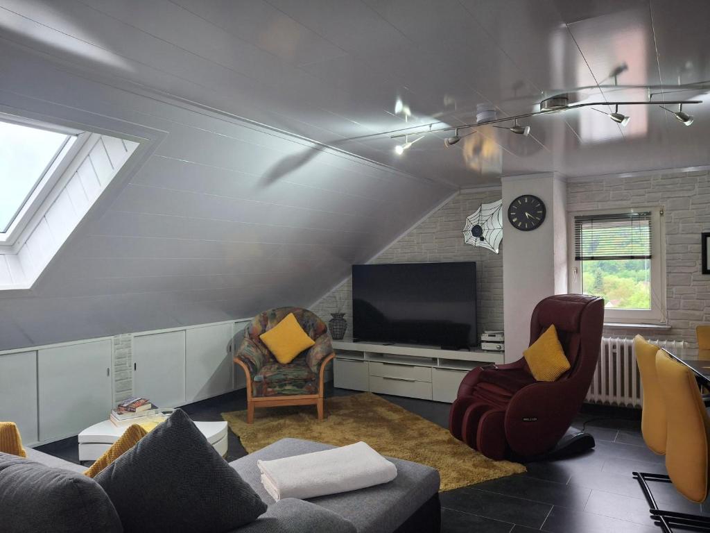 a living room with a couch and a tv at Ferienwohnung Anke Günther Dach in Bad Kissingen