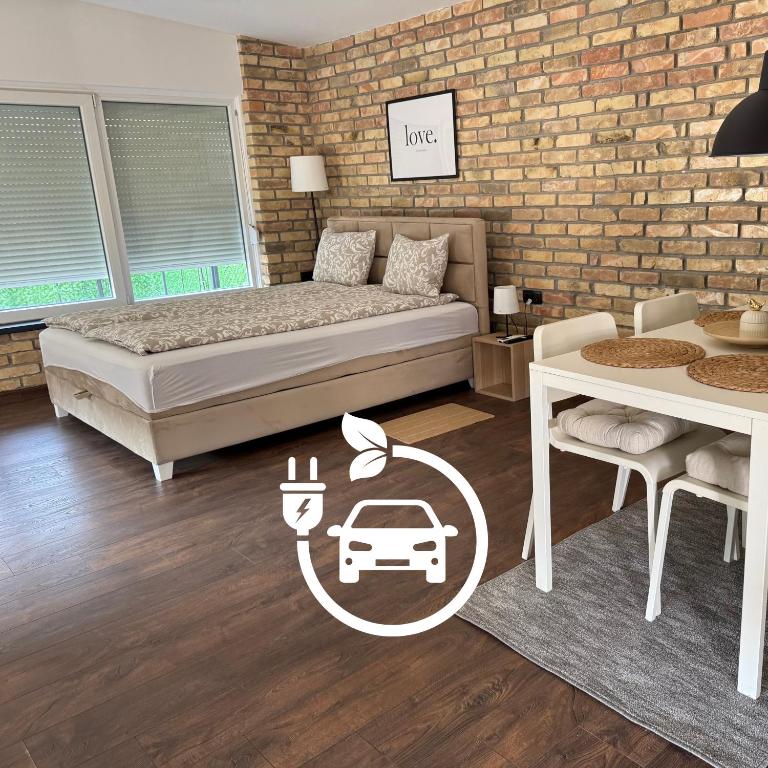 a bedroom with a bed and a brick wall at Apartmani Petra Bezdan in Bezdan