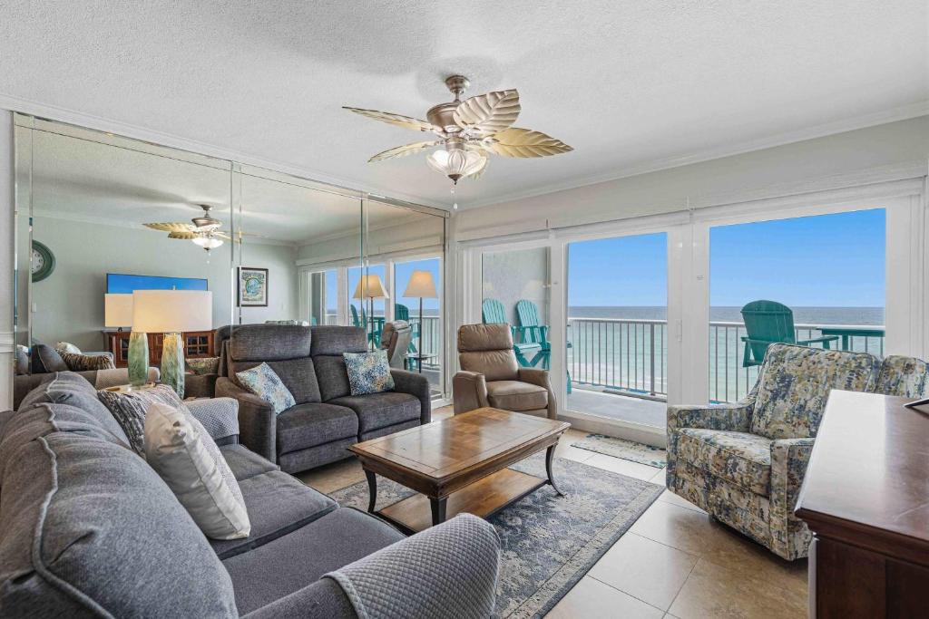 a living room with a couch and a table at Islander E 7011 Stunning oceanfront condo with pool & gym access in Fort Walton Beach