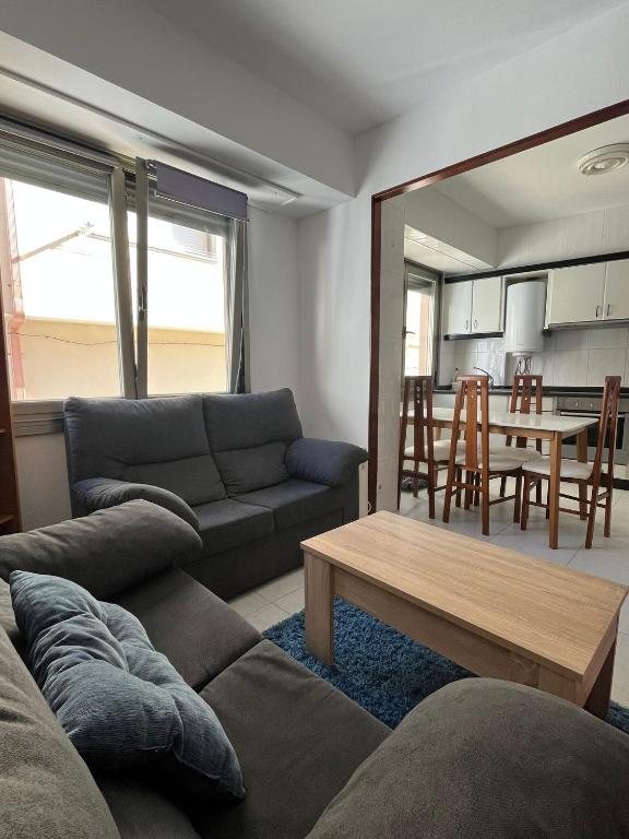 a living room with a couch and a table at Recuncho de Corme, a 100 metros de la playa in Corme-Puerto