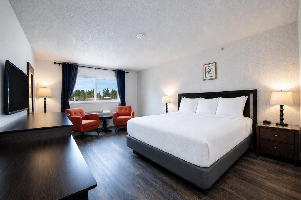 a hotel room with a large bed and a window at Hotel International in Lynnwood