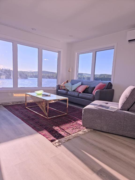 a living room with a couch and a table at The View in French Village