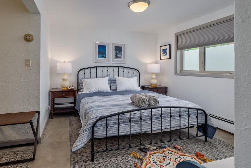a bedroom with a bed with two night stands and a window at 2 Mins from Airport 1 BDR with Large Backyard in Anchorage