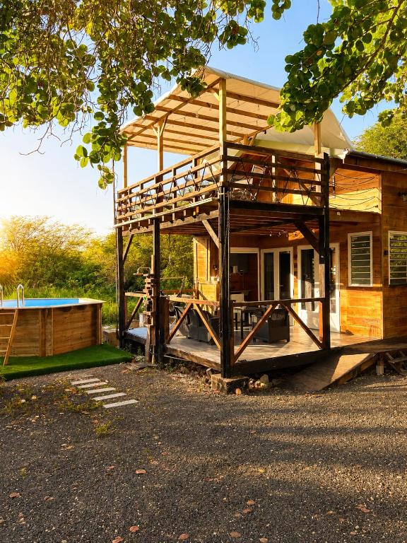 a house with a deck and a pool at evasion guadeloupe in Malgré Tout