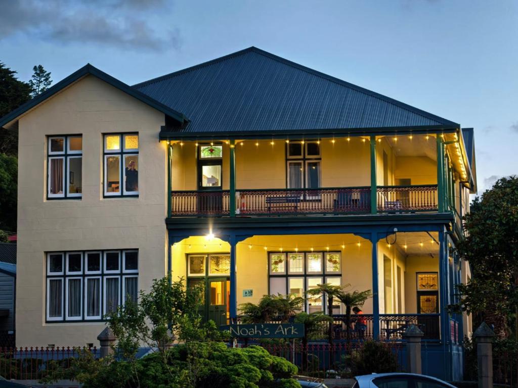 a large white house with lights on it at Noah's Ark Flashpacker in Greymouth