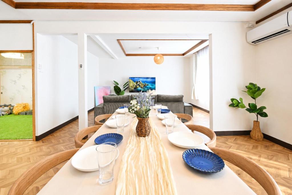 a dining room with a long table and chairs at HOSHIYA Kamifurano in Kami-furano