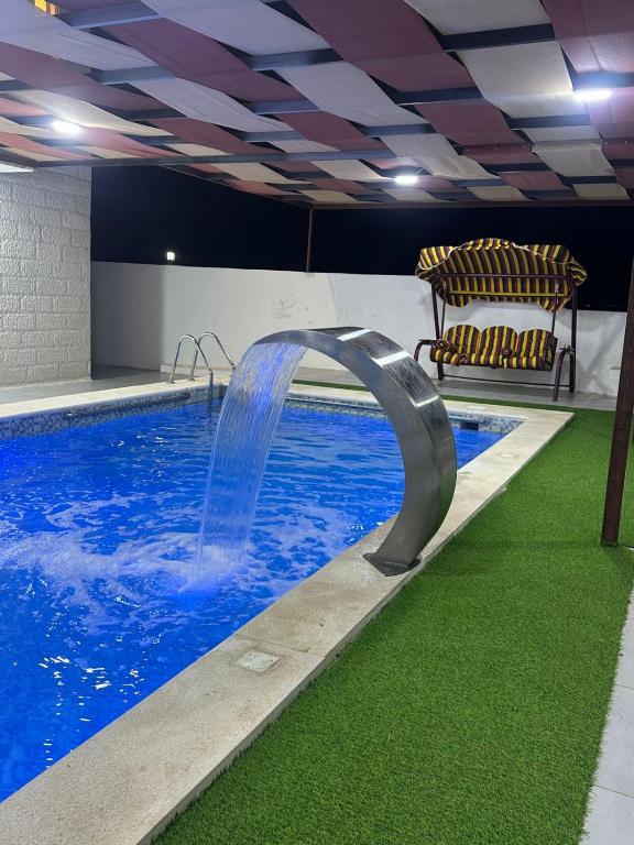 a swimming pool with a water slide in a room at La mira chalet in Madaba