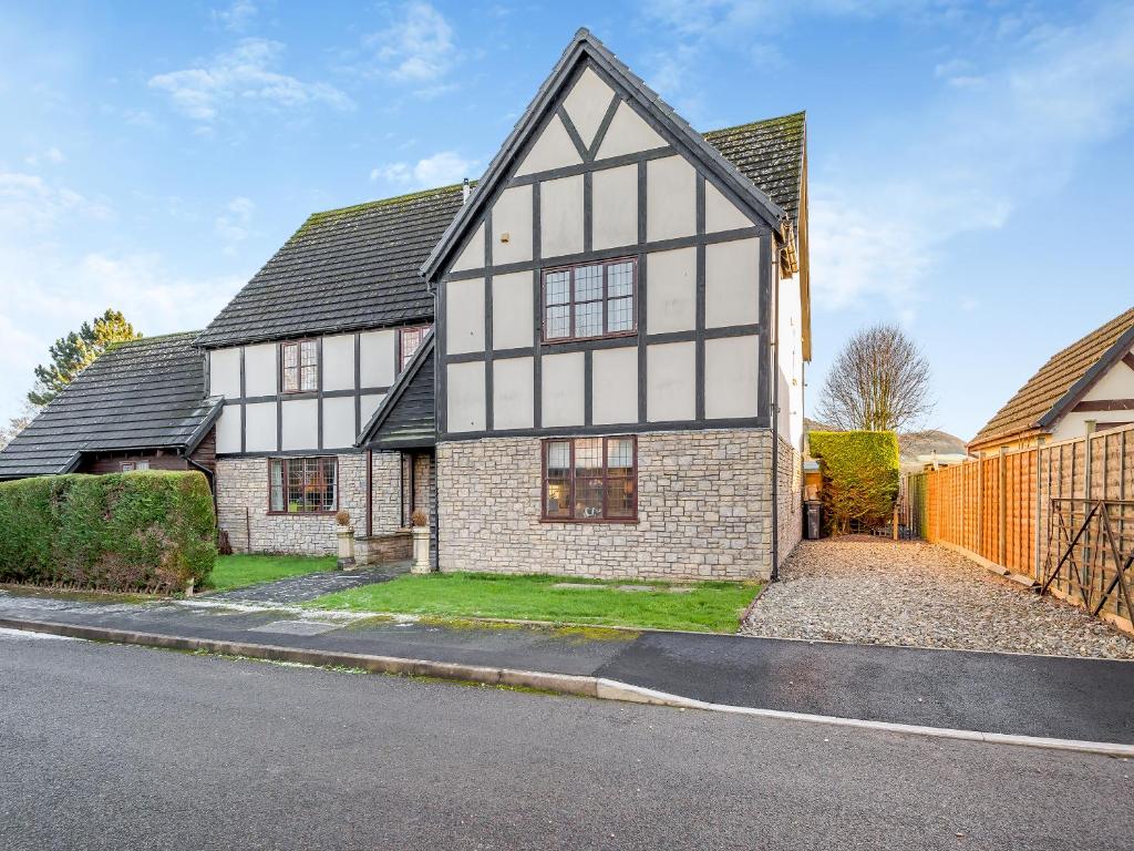 a white and black house on a street at Cromwell House - Uk42450 in Winforton