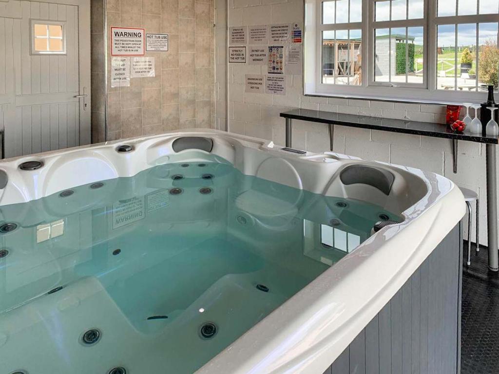 a large bath tub in a room with at Red Kite Cottage-Ukc6982 in Consett