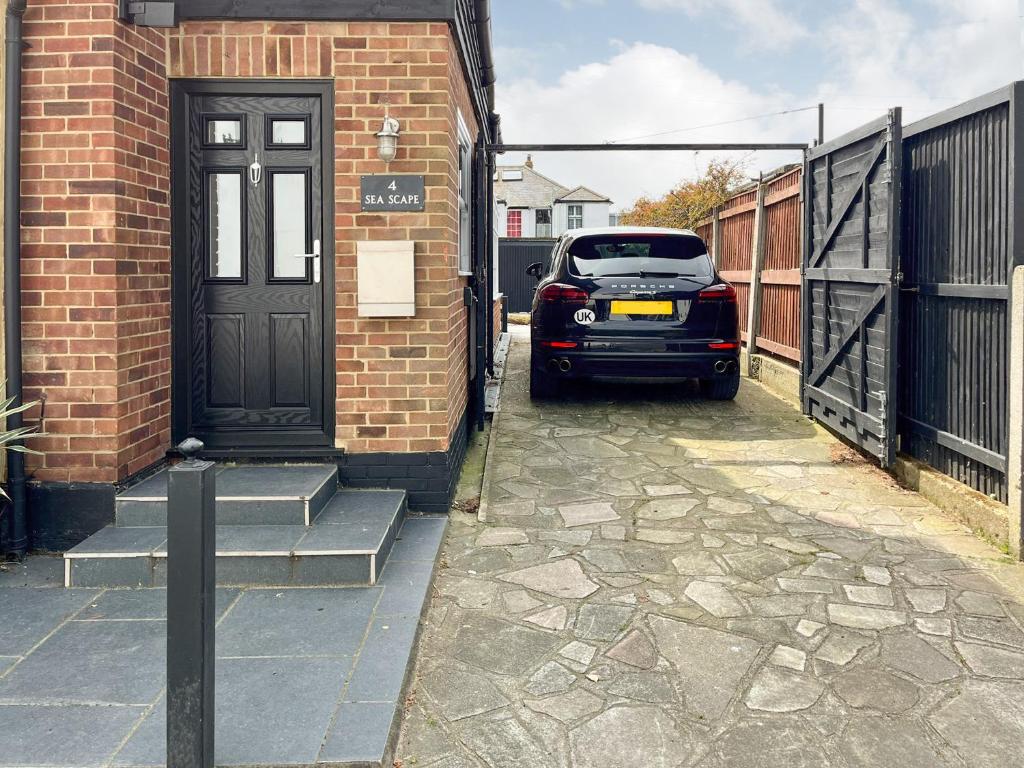 a car parked in front of a house with a door at Sea Scape in Whitstable