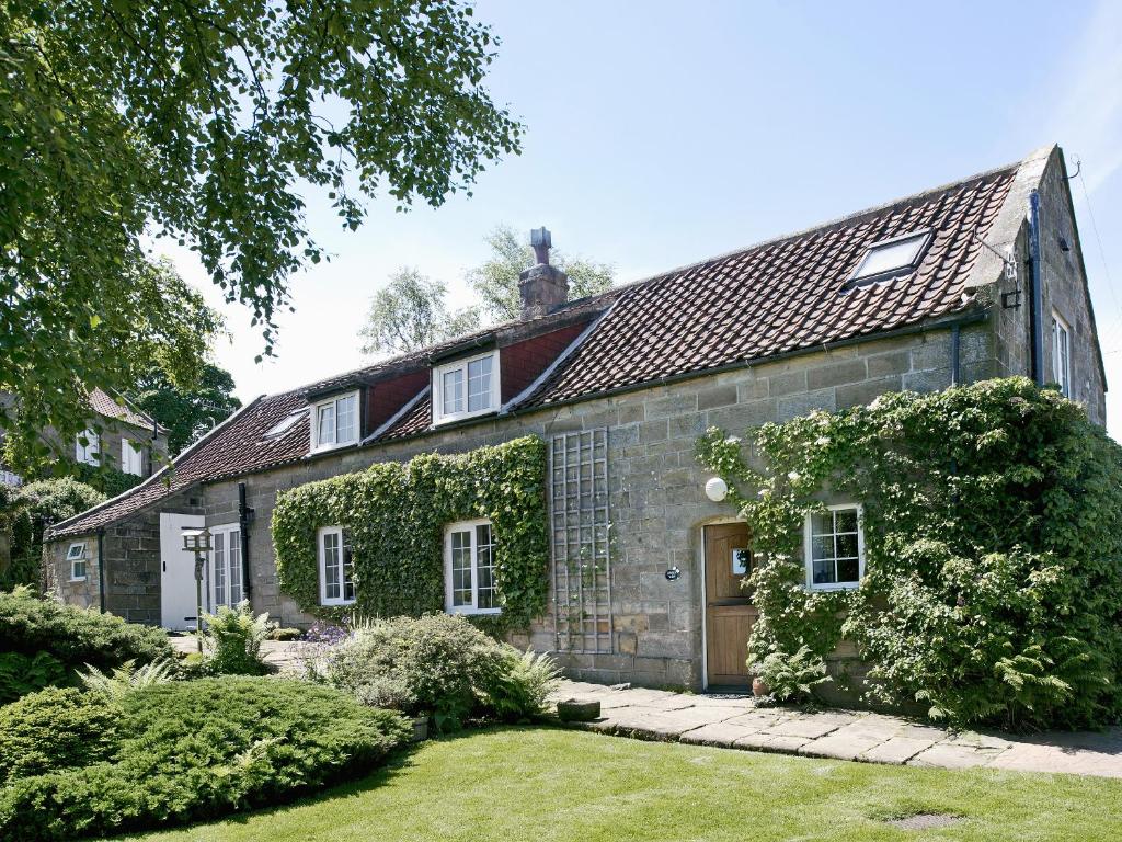 an old stone house with ivy growing on it at Limber View in Glaisdale