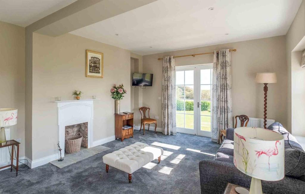 a living room with a couch and a fireplace at The Dower House in Thorpeness