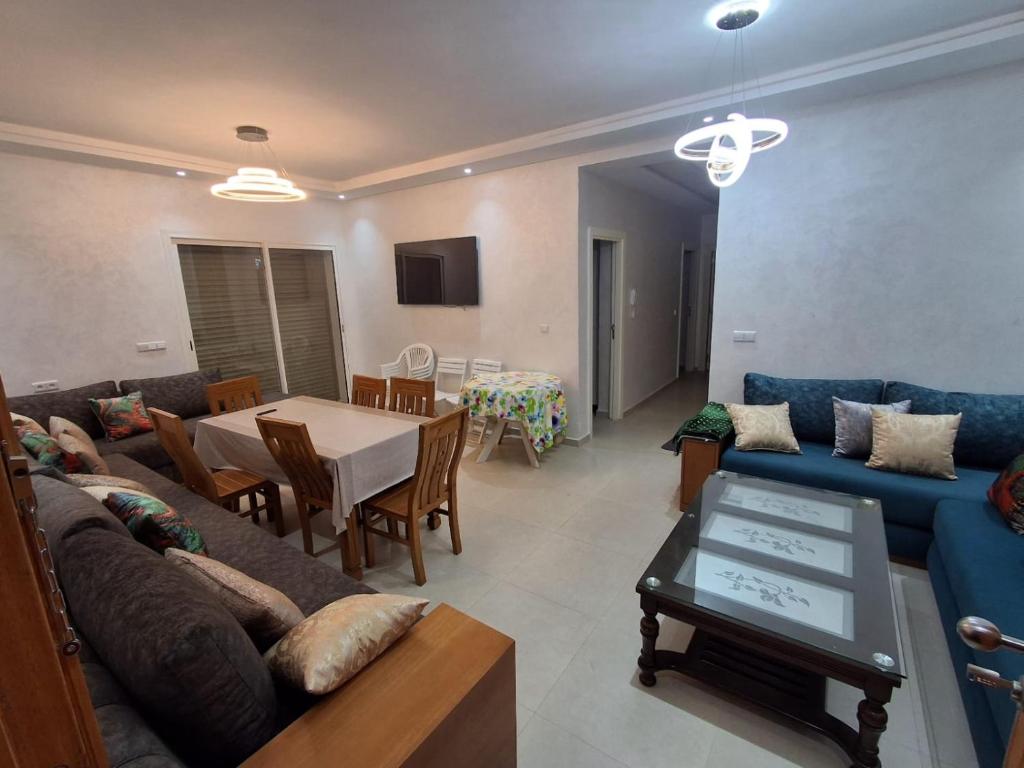 a living room with a couch and a table at Appartement Residence Tafoult IMIOUADDAR in Agadir nʼ Aït Sa