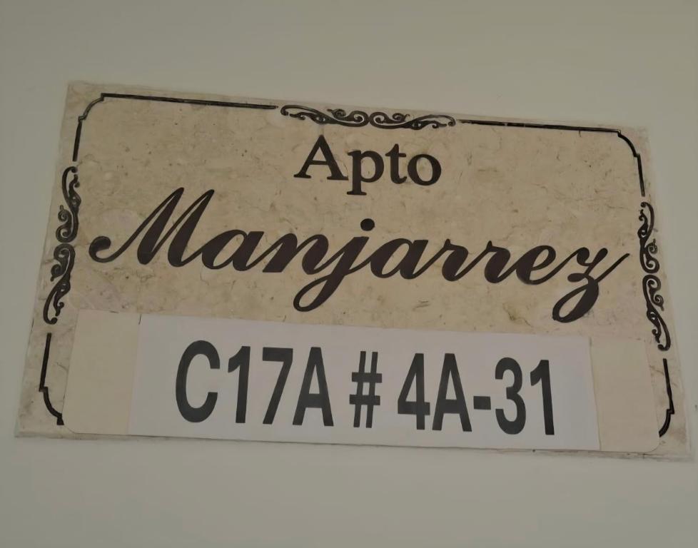 a sign that says apollo mannery on it at Apartamento Manjarrez 4 Compartido in Mompos