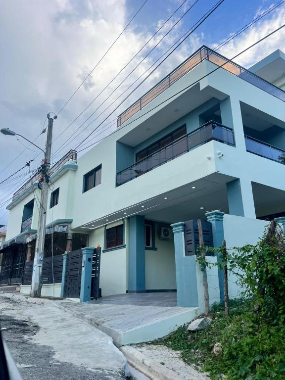 a blue and white building with a balcony at Luma Residence in San Felipe de Puerto Plata