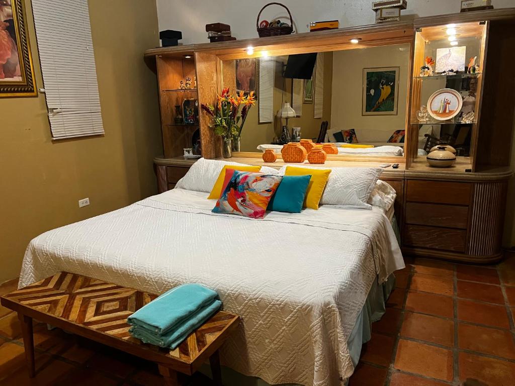 a bedroom with two beds and a table at Villa Vassallo in Ponce