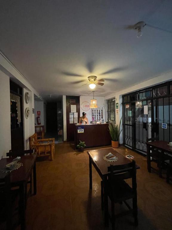 a living room with tables and a ceiling fan at Hosp Norte Los Organos in Los Órganos