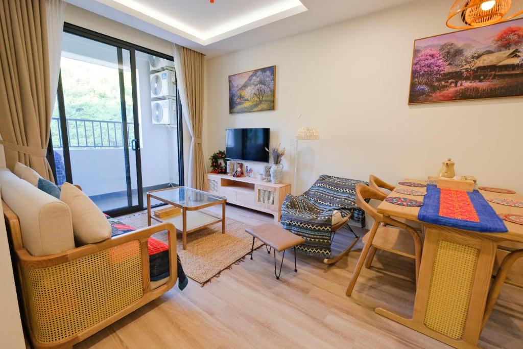 a living room with a table and a dining room at Lia Home in Sapa