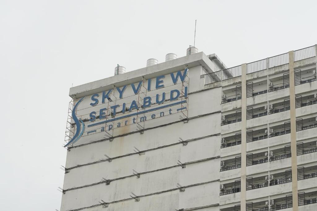a building with a sign on the side of it at Skyview Apartment by Grand Sky Hotel in Sunggal
