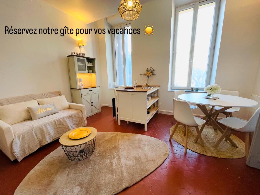 a living room with a couch and a table at GITE chez "Chambre D'Hôtes Sandra" in Annot