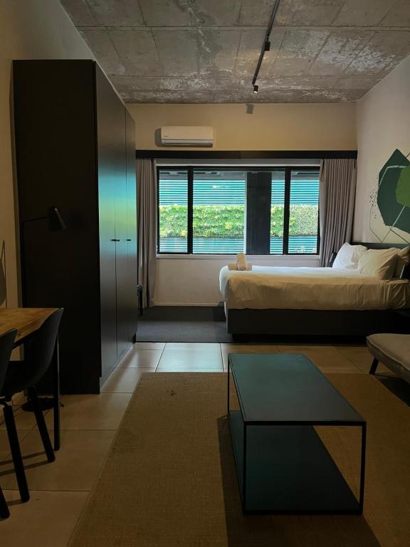 a bedroom with a bed and a table in a room at Sandton CBD apartment in Johannesburg