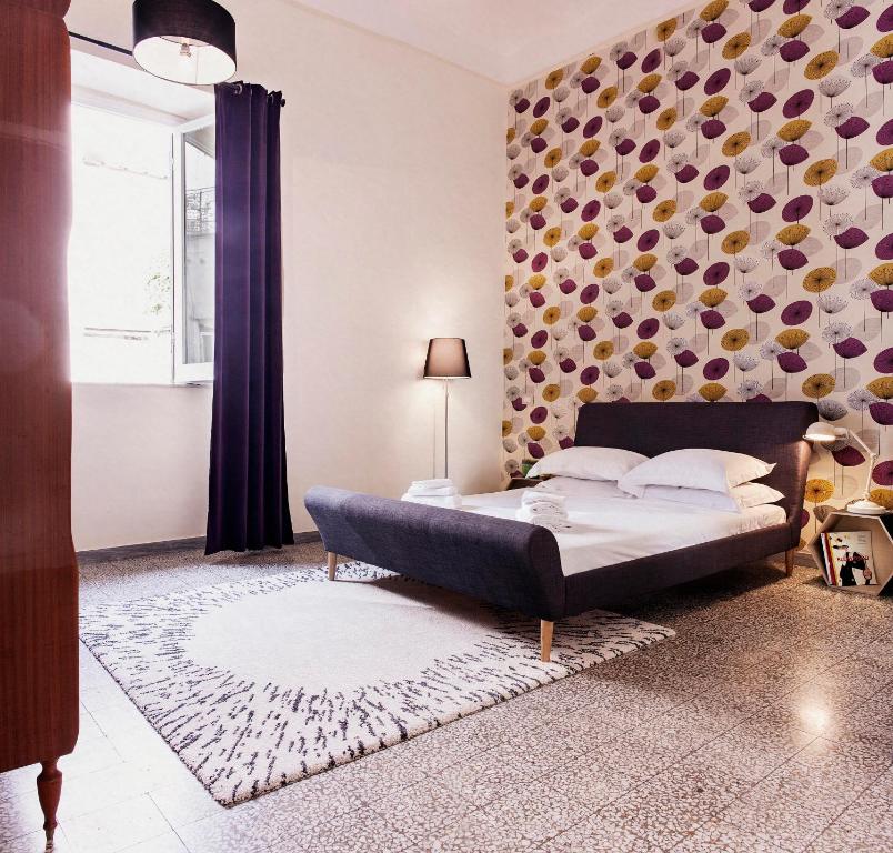 ローマにあるPeretti Rome Trastevere Homeの壁のある部屋のベッド1台が備わるベッドルーム1室を利用します。