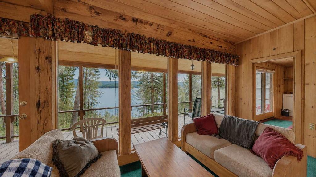 a living room with a couch and a table at McCall Lakehouse Private Dock Beach & Grill in McCall