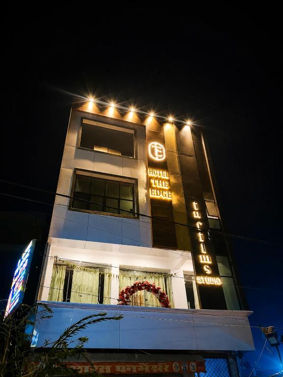 a building with lights on top of it at night at Hotel The Edge in Rewa