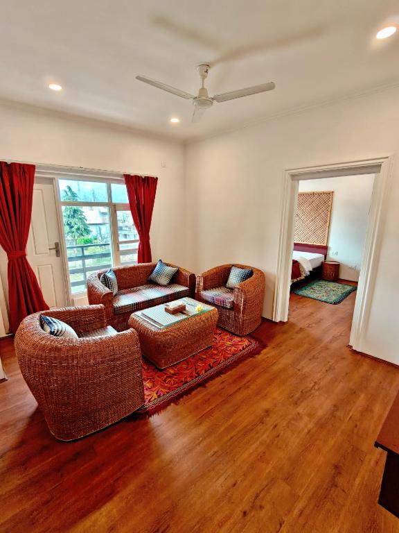 a living room with two couches and a table at Maskan by Rafiqi Estates - Deluxe 2BHK & Studio Apartments in Srinagar