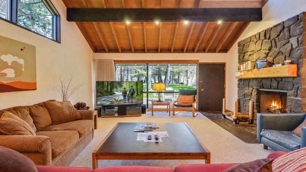 a living room with a couch and a fireplace at Meadow House 21 in Sunriver